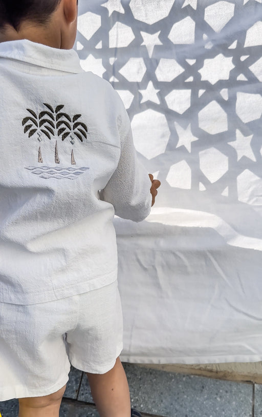 Boy in Ramadan muslin linen set with embroidered palm tree motif
