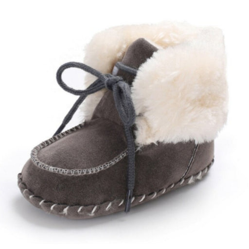Soft suede baby booties in black with off white fur lining. Perfect for your little ones first steps!